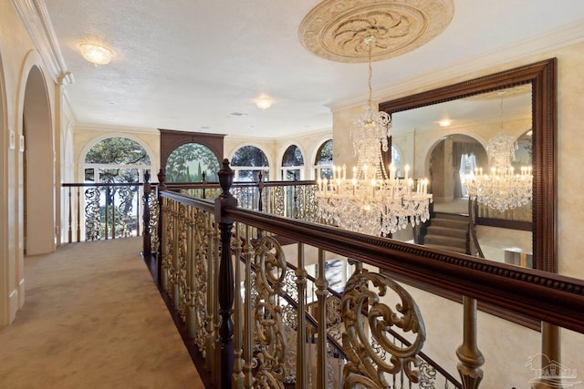 721 W Miracle Strip Pkwy, Mary Esther, FL 32569 - hallway featuring carpet, ornamental molding, an upstairs landing, an inviting chandelier, and arched walkways