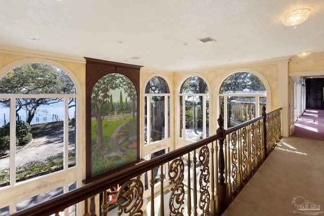 721 W Miracle Strip Pkwy, Mary Esther, FL 32569 - hall with visible vents, a healthy amount of sunlight, ornamental molding, and carpet flooring