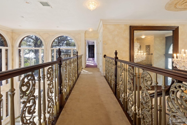 721 W Miracle Strip Pkwy, Mary Esther, FL 32569 - hall featuring visible vents, an upstairs landing, light carpet, crown molding, and a chandelier