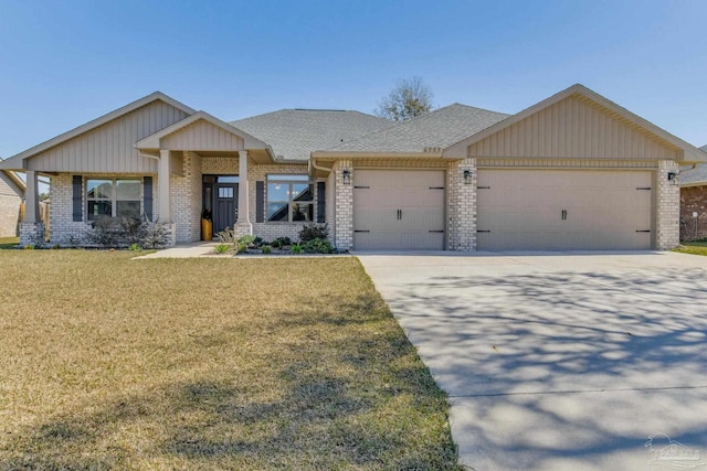 view of front facade featuring brick siding, a front yard, concrete driveway, and an attached garage