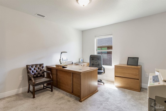 home office with light colored carpet, visible vents, and baseboards