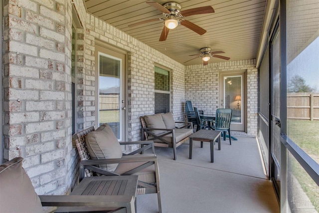 sunroom / solarium with a wealth of natural light and ceiling fan