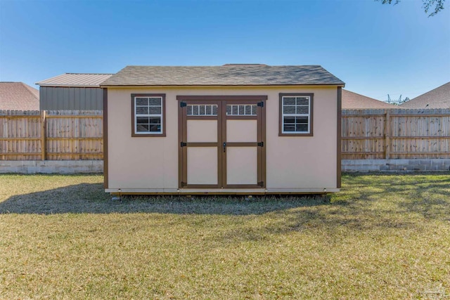 view of shed with a fenced backyard