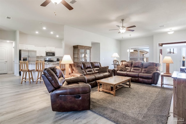 living area with recessed lighting, visible vents, light wood-style floors, and a ceiling fan