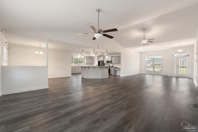 5619 Burr St, Milton, FL 32570 - unfurnished living room featuring plenty of natural light, dark wood finished floors, and ceiling fan with notable chandelier