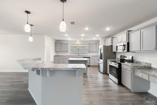 5619 Burr St, Milton, FL 32570 - kitchen featuring a center island, stainless steel appliances, gray cabinetry, visible vents, and dark wood-style floors