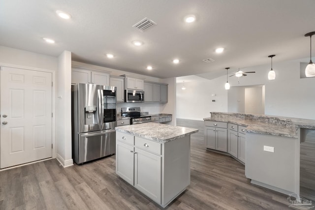 5619 Burr St, Milton, FL 32570 - kitchen featuring visible vents, dark wood-style floors, a center island, gray cabinetry, and stainless steel appliances