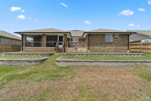 5619 Burr St, Milton, FL 32570 - rear view of house featuring a yard, a sunroom, fence private yard, and brick siding