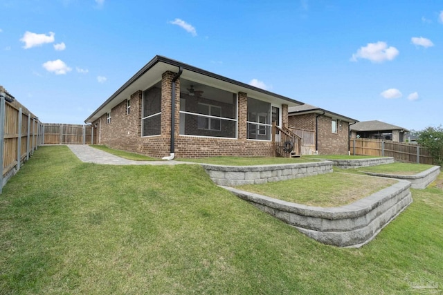 5619 Burr St, Milton, FL 32570 - rear view of property with a lawn, brick siding, a ceiling fan, and a fenced backyard