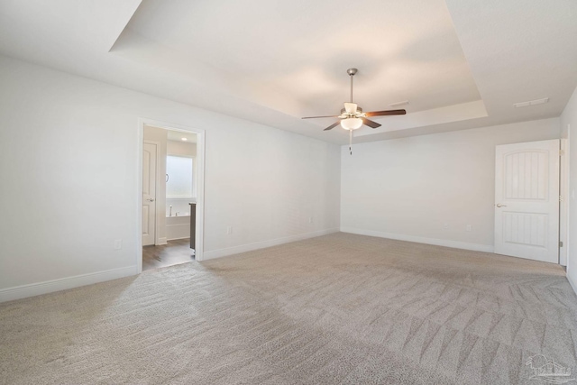 5619 Burr St, Milton, FL 32570 - spare room with a raised ceiling, baseboards, a ceiling fan, and carpet floors