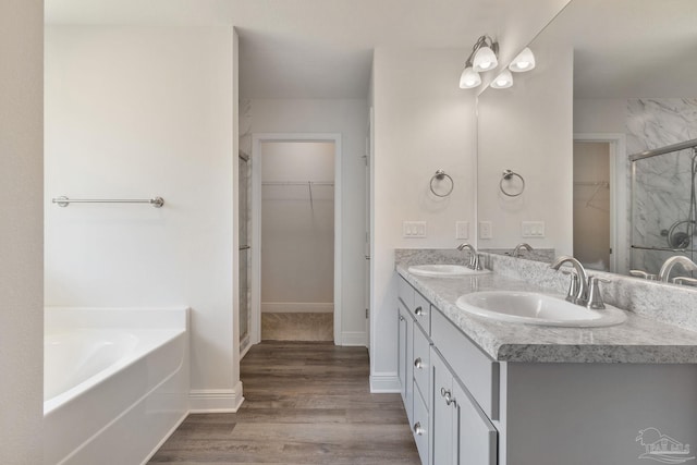 5619 Burr St, Milton, FL 32570 - full bathroom featuring a sink, double vanity, wood finished floors, and a spacious closet