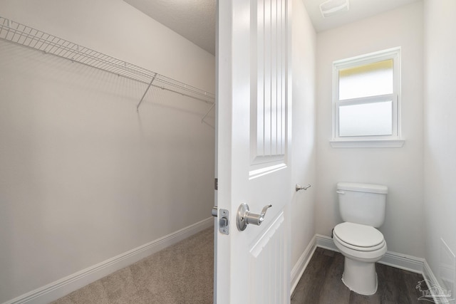 5619 Burr St, Milton, FL 32570 - bathroom with baseboards, a walk in closet, toilet, and visible vents