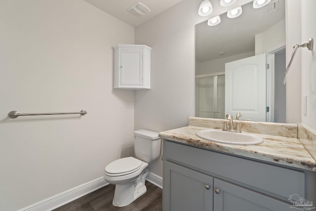 5619 Burr St, Milton, FL 32570 - full bath with vanity, wood finished floors, toilet, baseboards, and a shower stall