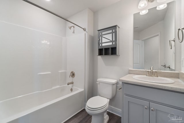 5619 Burr St, Milton, FL 32570 - full bath featuring shower / tub combination, wood finished floors, vanity, baseboards, and toilet