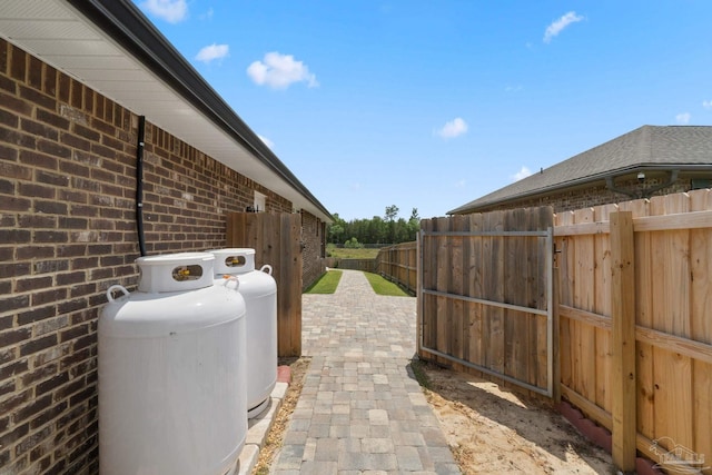5619 Burr St, Milton, FL 32570 - view of side of home with brick siding and fence