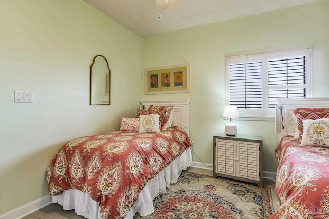 bedroom with ceiling fan and wood-type flooring