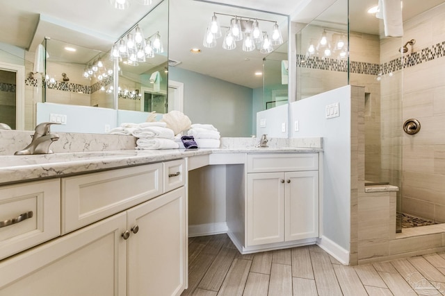 bathroom with vanity and tiled shower