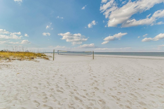 surrounding community with a water view and a view of the beach