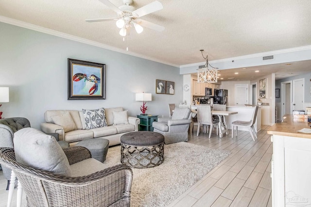 living room with crown molding, ceiling fan with notable chandelier, light hardwood / wood-style floors, and a textured ceiling