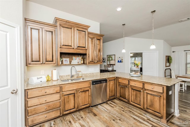 kitchen featuring a peninsula, a sink, visible vents, light wood-style floors, and dishwasher