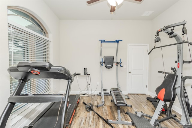 workout area featuring a ceiling fan, baseboards, and wood finished floors