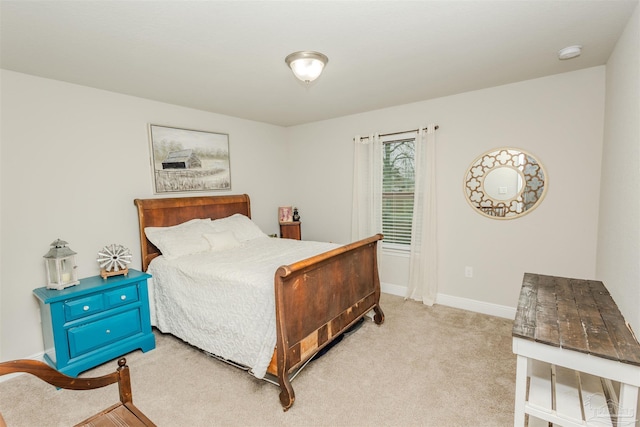 bedroom featuring baseboards and light colored carpet