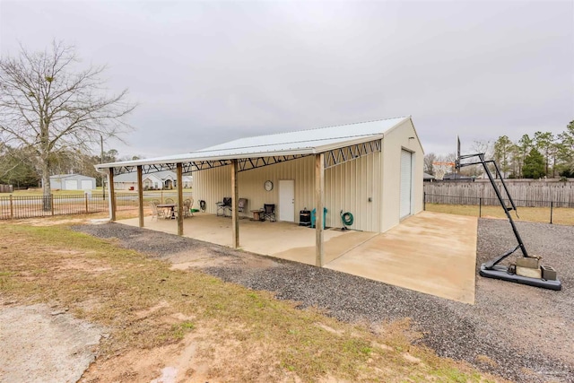 exterior space featuring an outdoor structure and fence