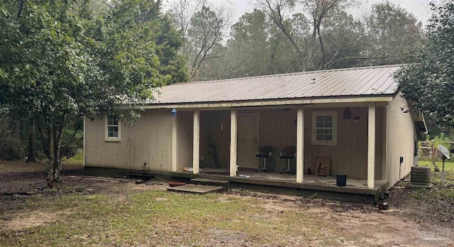 back of house featuring central air condition unit