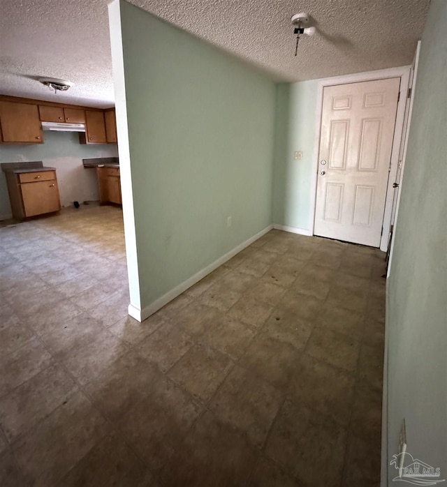 unfurnished room featuring a textured ceiling