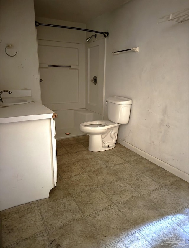 bathroom with toilet, walk in shower, and vanity