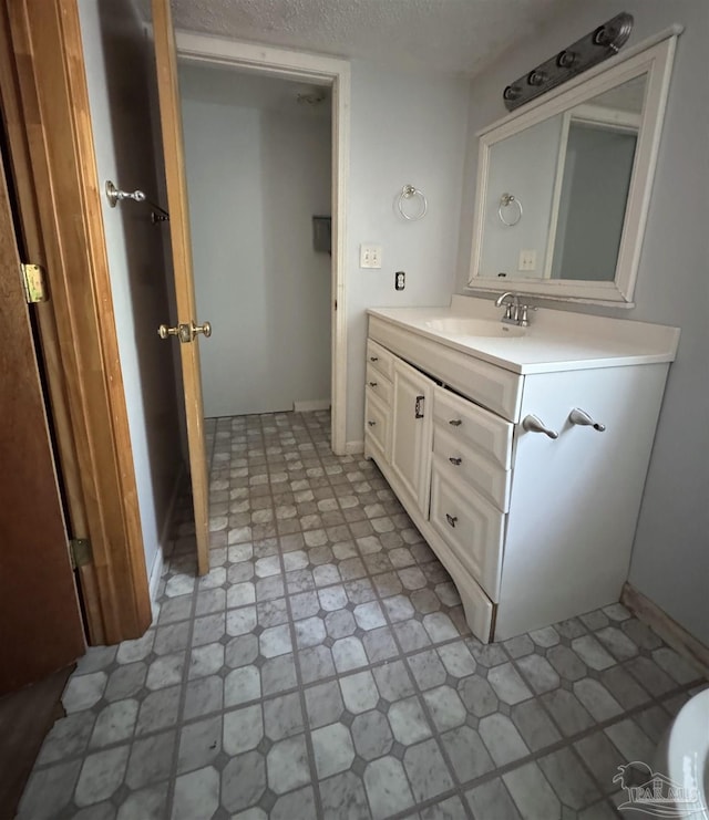 bathroom featuring vanity and a textured ceiling