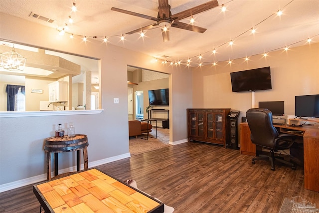 office featuring baseboards, visible vents, wood finished floors, and ceiling fan with notable chandelier