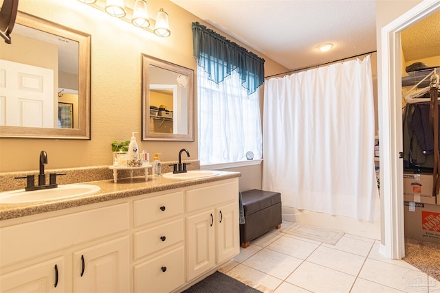 full bath with double vanity, tile patterned flooring, shower / bathtub combination with curtain, and a sink