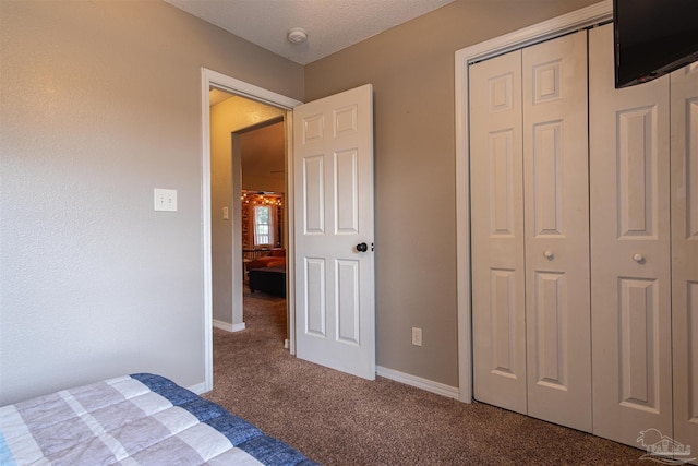 unfurnished bedroom with a closet, carpet flooring, and baseboards