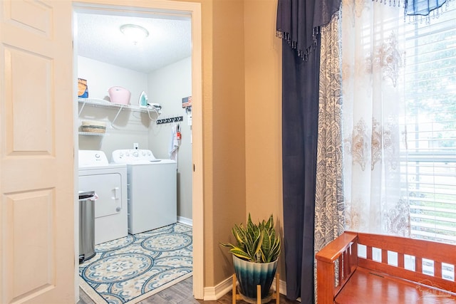 washroom featuring a textured ceiling, hardwood / wood-style floors, and washer and clothes dryer