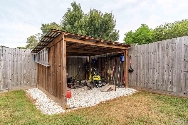 view of outbuilding featuring a lawn