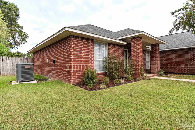 view of property exterior featuring a yard and central air condition unit