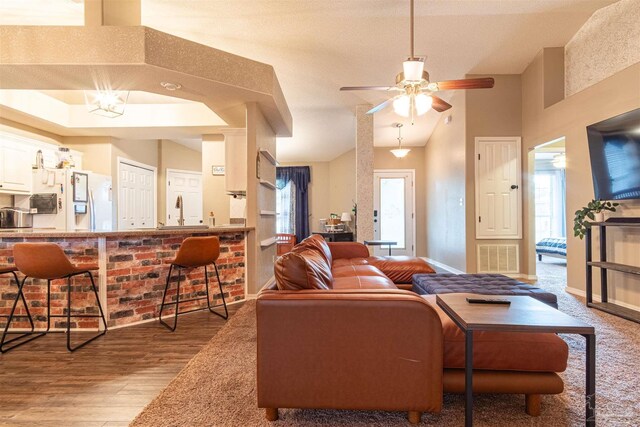 living room featuring a wealth of natural light, ceiling fan, hardwood / wood-style floors, and a textured ceiling