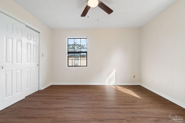 unfurnished bedroom featuring dark hardwood / wood-style flooring and ceiling fan