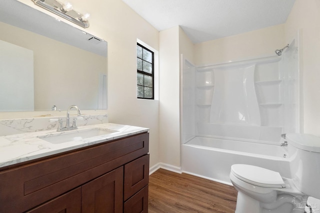 full bathroom featuring vanity, wood-type flooring, toilet, and shower / bath combination