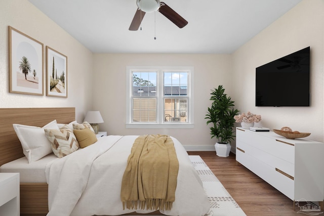 bedroom with ceiling fan and dark hardwood / wood-style flooring