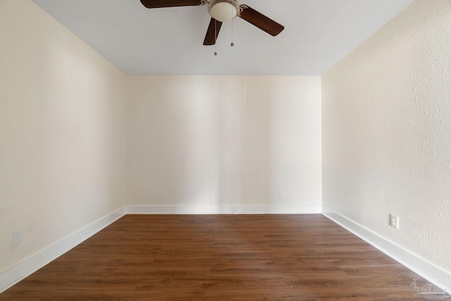 empty room featuring ceiling fan and dark hardwood / wood-style flooring