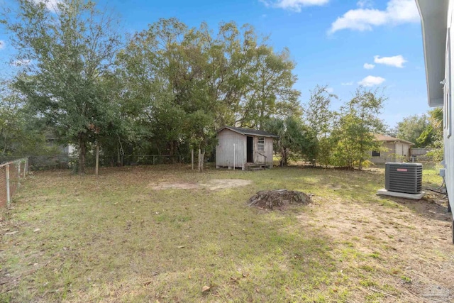 view of yard featuring central AC unit and a shed