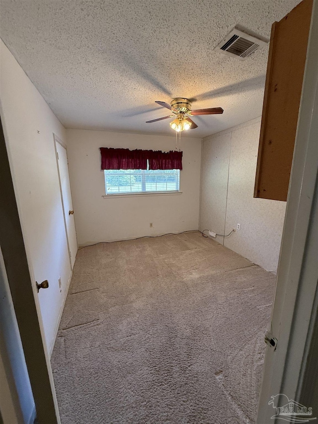 5402 Douglas St, Milton, FL 32570 - spare room with a textured ceiling, light colored carpet, and ceiling fan