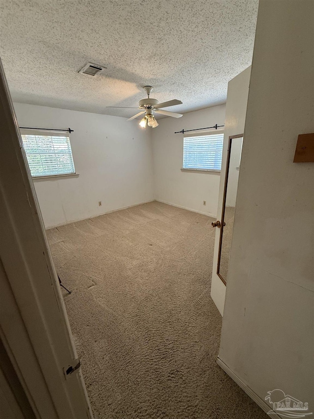 5402 Douglas St, Milton, FL 32570 - carpeted empty room featuring a ceiling fan and a textured ceiling