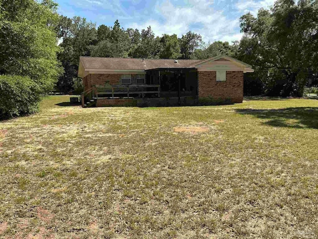 5402 Douglas St, Milton, FL 32570 - rear view of house featuring a yard and brick siding