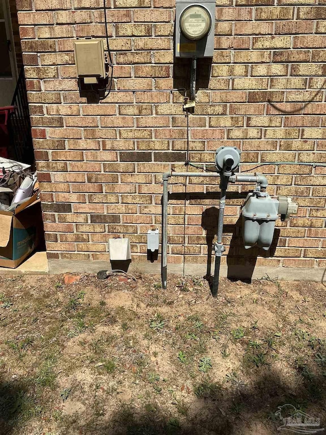 5402 Douglas St, Milton, FL 32570 - exterior view of electric meter, brick siding, and gas meter