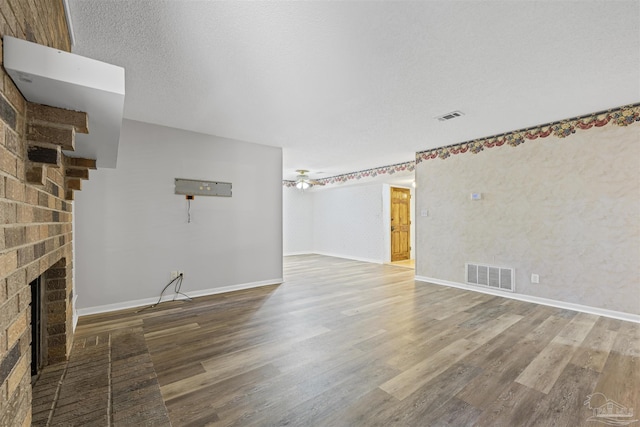 4831 E Olive Rd Unit 2A, Pensacola, FL 32514 - unfurnished living room with a fireplace, wood finished floors, baseboards, and ceiling fan