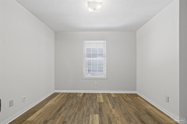 4831 E Olive Rd Unit 2A, Pensacola, FL 32514 - spare room with wood finished floors, a textured ceiling, and baseboards