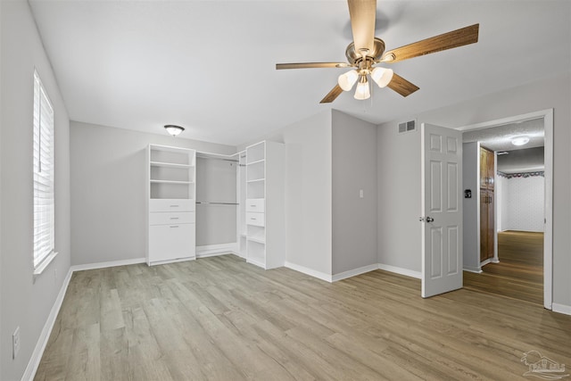 4831 E Olive Rd Unit 2A, Pensacola, FL 32514 - unfurnished bedroom featuring light wood-style flooring, baseboards, a ceiling fan, and a closet